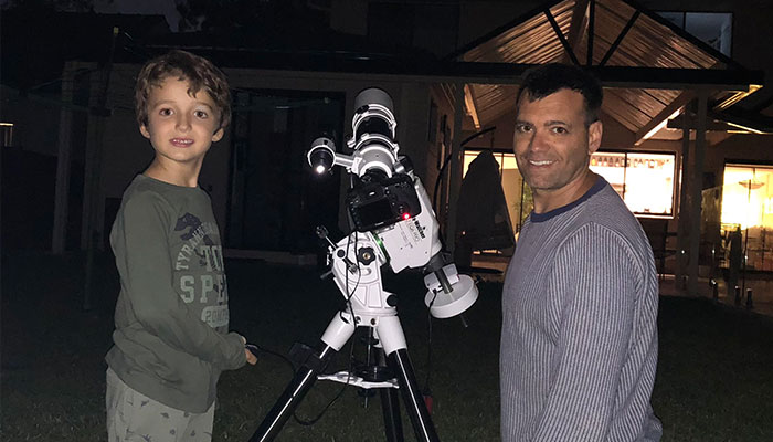 Angel Lopez Sanchez and son observing the night sky.