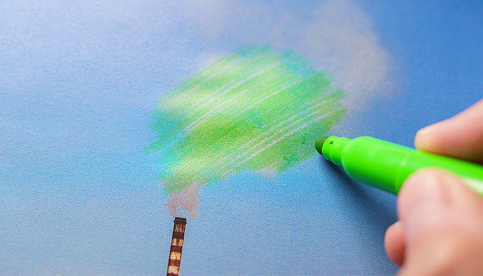 Pollution being painted green from a chimney