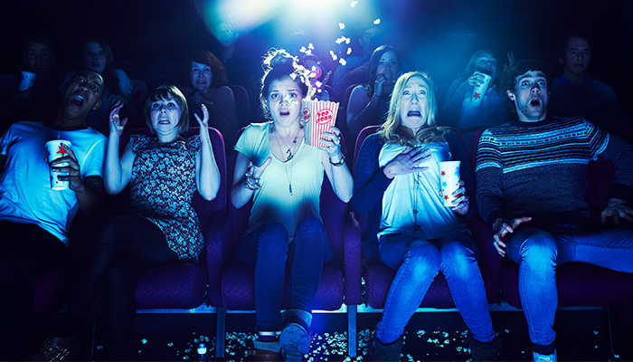 Audience looking terrified in a scary movie