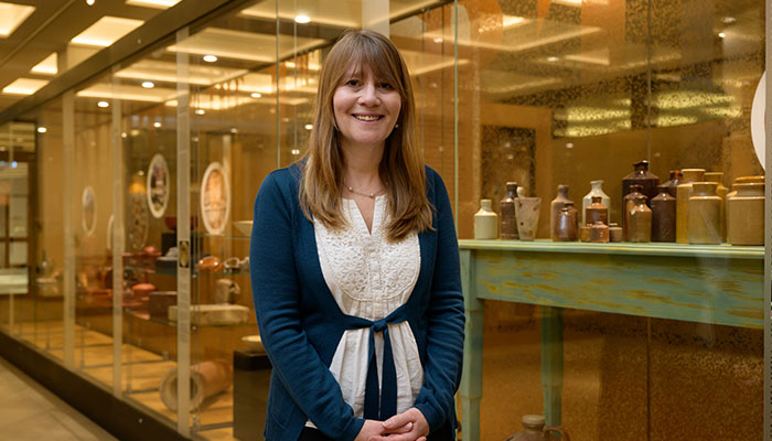 Susan Lupack with pottery from the latest exhibition at the Macquarie History Museum