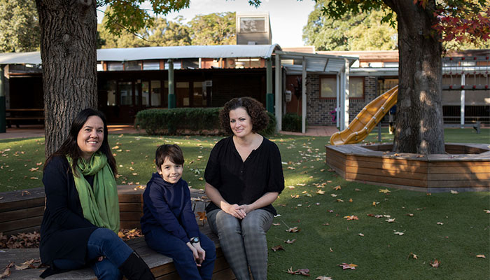 Dr Sara Mills at Macquarie University's MUSEC school with student Jayden and his mother Kerry.