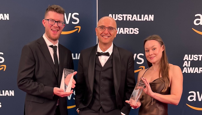 3 winners with a trophy