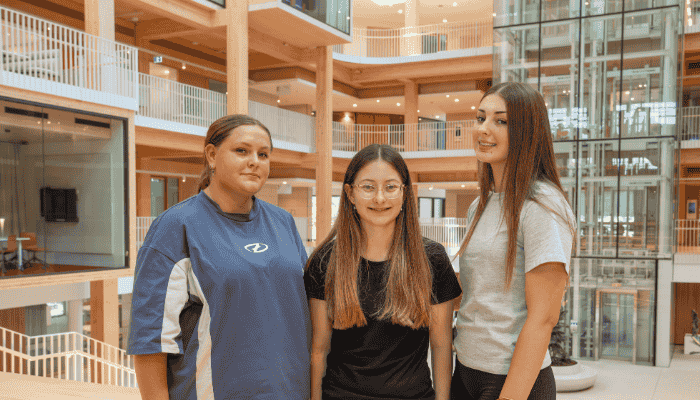 Krystal Johnson, Tamsyn Grillett and Charlotte Turley smile at the camera
