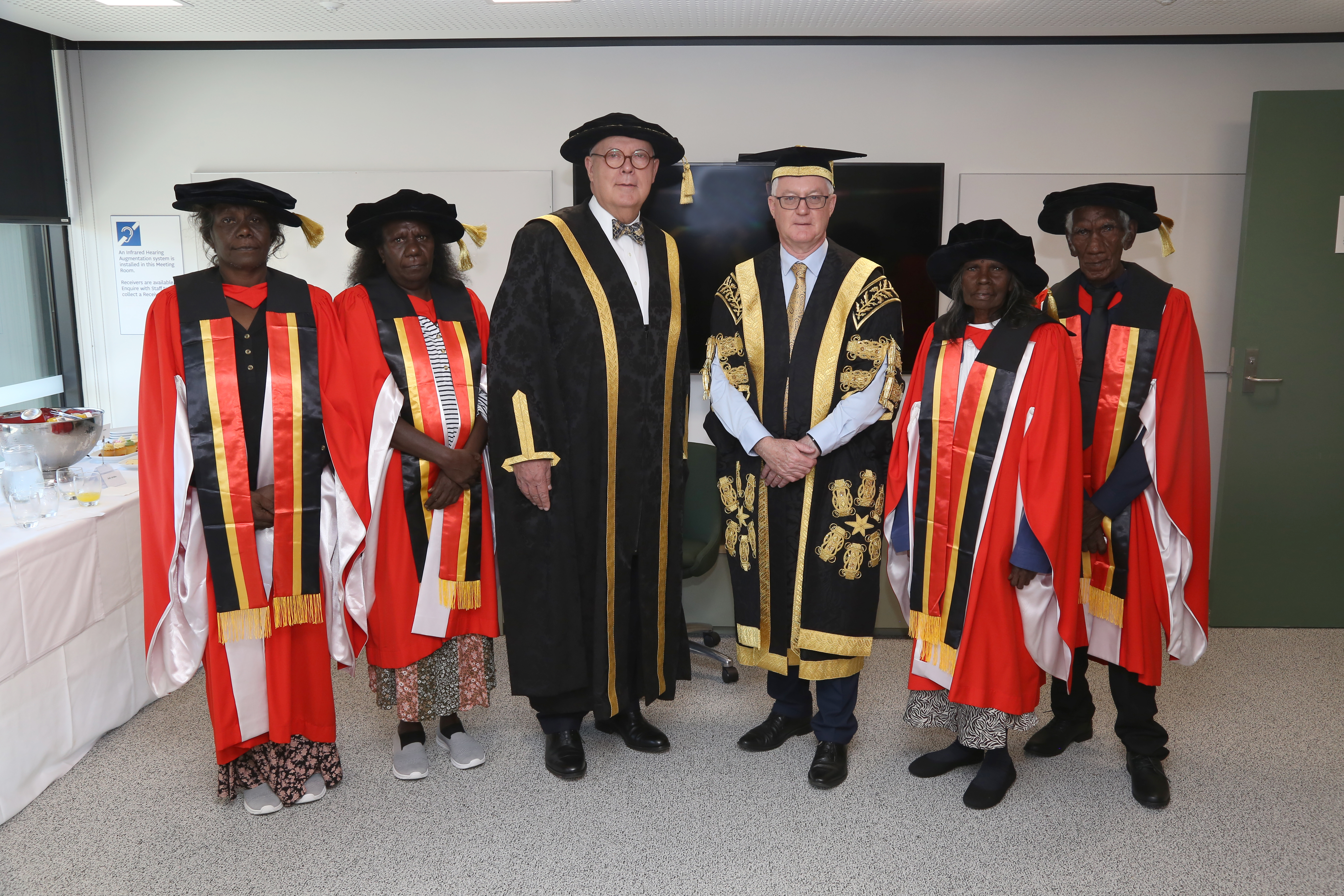 Pictured L to R: Annette Daniels and Geraldine Daniels, daughters of Honorary Doctorate recipient, the late Cherry Daniels OAM; Vice-Chanceller S Bruce Dowton; Chancellor Martin Parkinson; and Honorary Doctorate recipients Helen Gabibi Rogers and Kevin Guyurruyurru Rogers.