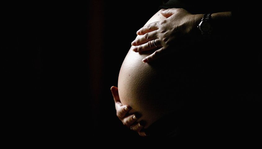 Pregnant women holding stomach