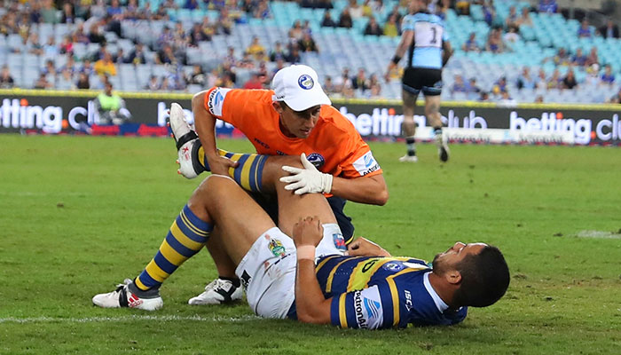 Jarryd Hayne is treated on the field for an injury during an NRL game
