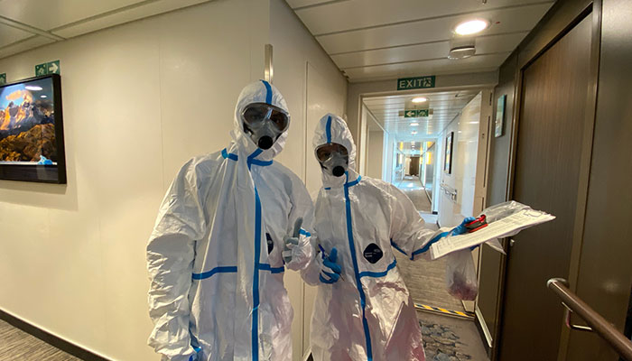 Border security staff in protective suits board the Greg Mortimer cruise ship in March 2020 after 81 per cent of passengers tested positive for covid-19.