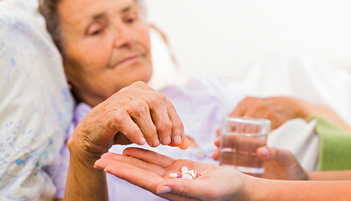 Elderly woman taking medication