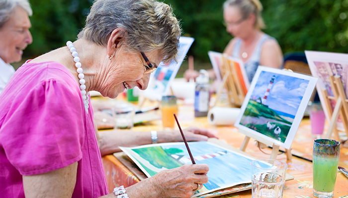 Older lady painting with friends